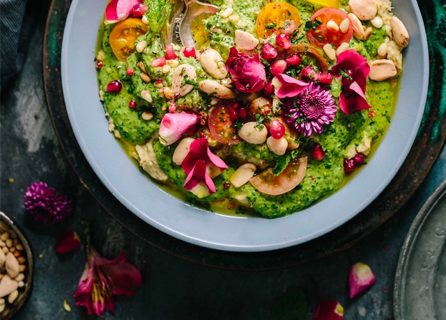 Overhead view of food with seeds, parsley, tomatoes, and other veggies & herbs